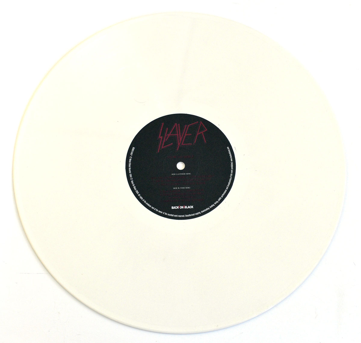 White vinyl record of Slayer's 'Show No Mercy' reissue featuring the Side A label with the Slayer logo and track details.